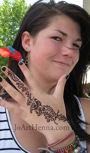 a nice floral finger design in henna on the hand